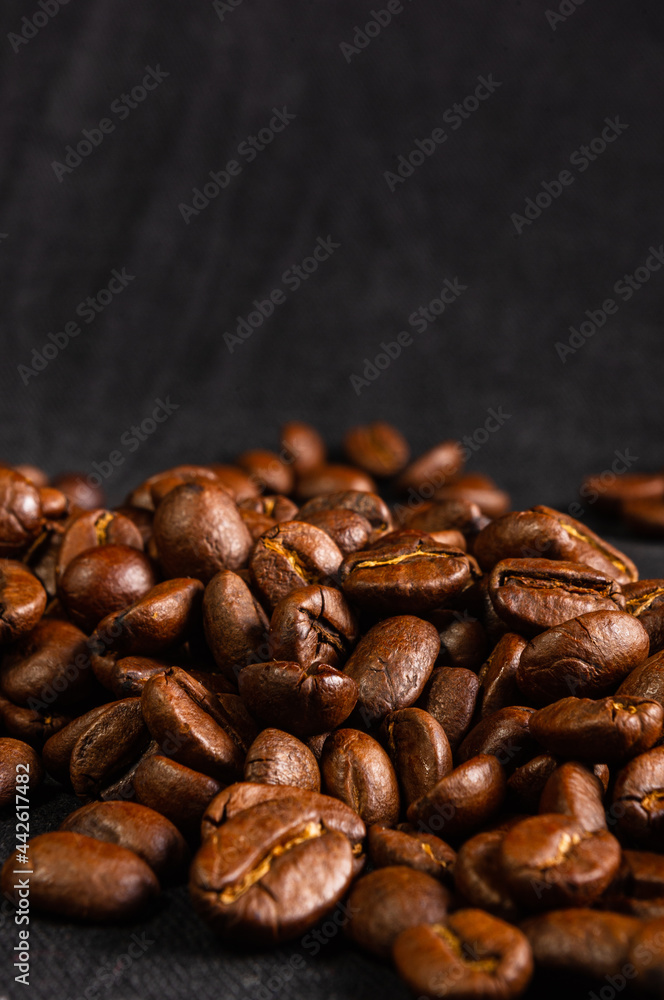 Natural background for Cafe menu or brochure template - macro photo of brown roasted coffee beans, close up Natural background for Cafe menu or brochure template - macro photo of brown roasted coffee beans, close up