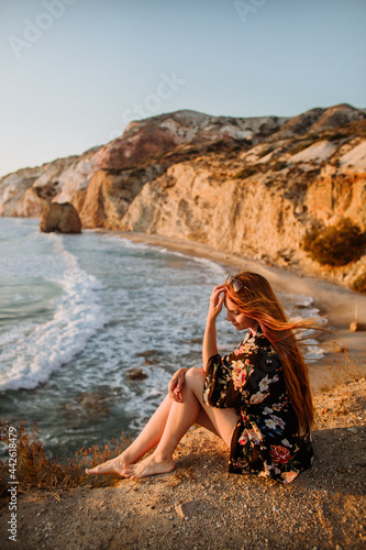 Woman sitting on scenic rocky coast photo