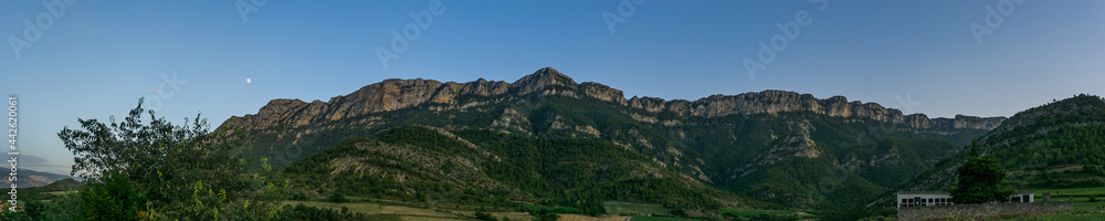 Panorama of pyrenees rocks at blue hour with moon on the sky, Spain Panorama of pyrenees rocks at blue hour with moon on the sky, Spain