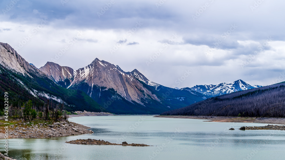 Medicine Lake in Jasper National Park in the Canadian Rockies under Dark Clouds. The lake fills and empties annually as the water drains through an underground drainage system