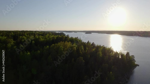 Aerial view over trees on a island, in the archipelago of Stockholm, in south Sweden - rising, drone shot photo