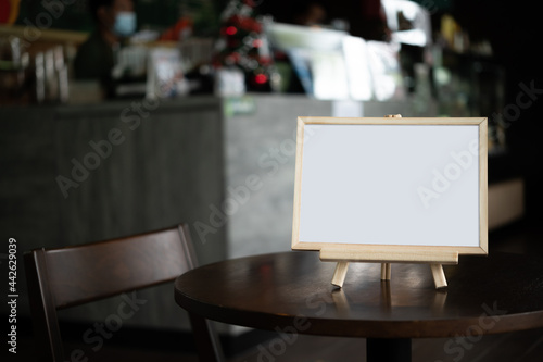 Picture frame placed on a table in a restaurant.