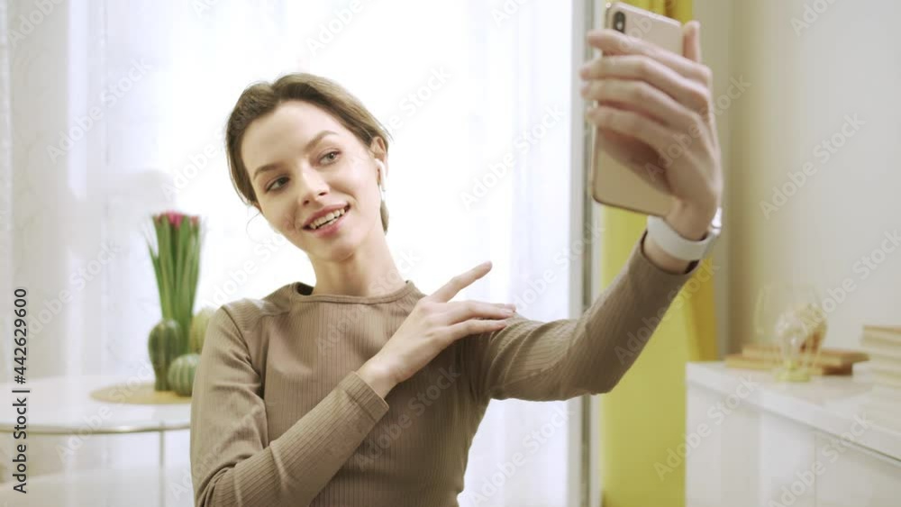 A beautiful woman is posing and taking a photo A beautiful woman is posing and taking a photo