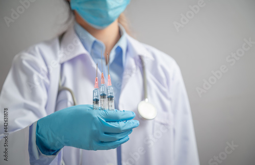 Doctor or scientist holding syringe with liquid vaccines booster. fight against virus covid-19 coronavirus, Vaccination and immunization. diseases,medical care,science, vaccine booster concept.
