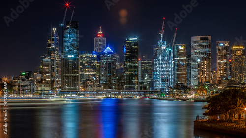 Sydney city high rise buildings night lights reflect across Circular Quay and the harbour. © gshakwon