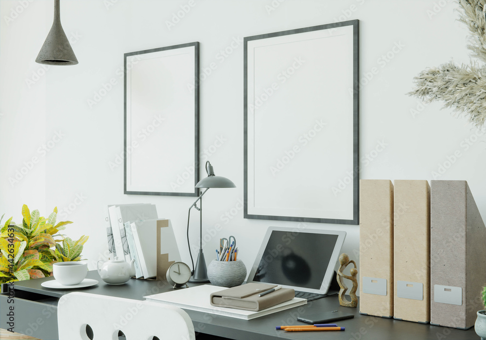 A working room with tablets, books, pens and smartphones on the table. A working room with tablets, books, pens and smartphones on the table.