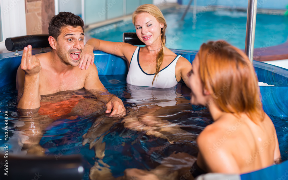 Fototapeta premium Three friends are resting in pool in time spa-day in salon.