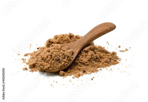Brown cane sugar with wooden spoon isolated on white background
