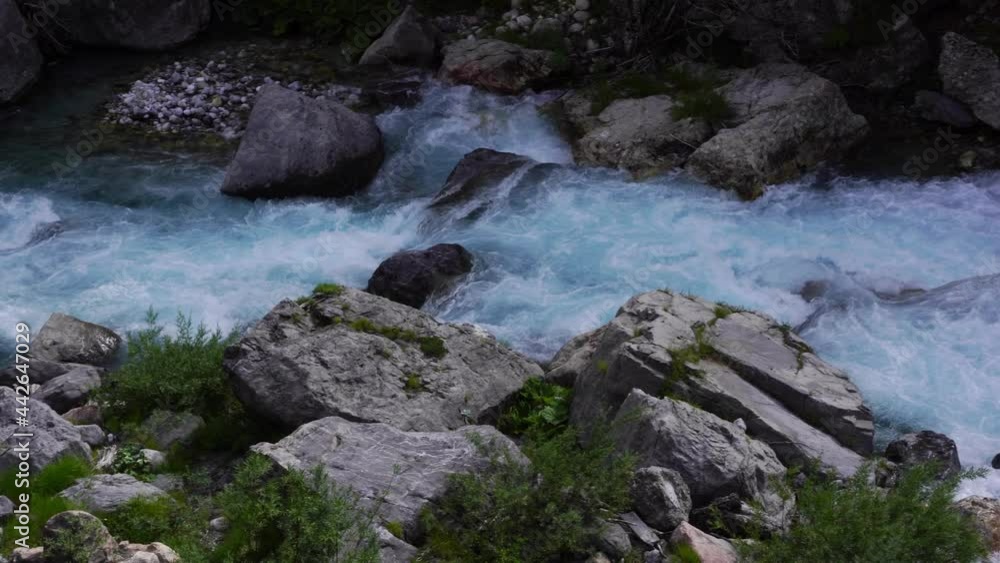 River water foaming and splashing on cliffs of Alpine Mountains in Theth, Albania River water foaming and splashing on cliffs of Alpine Mountains in Theth, Albania