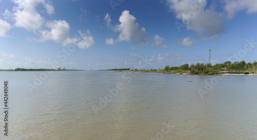 The Calcasieu River at Cameron Pass Louisiana as seen from the car ferry. The Gulf of Mexico is 3 miles straight ahead passing a coastal prairie with abundant wildlife.