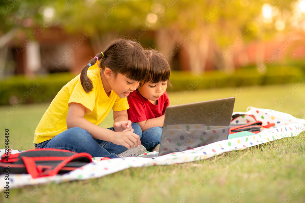 Two asian child girl students study online with teacher by video call together. Two asian child girl students study online with teacher by video call together.