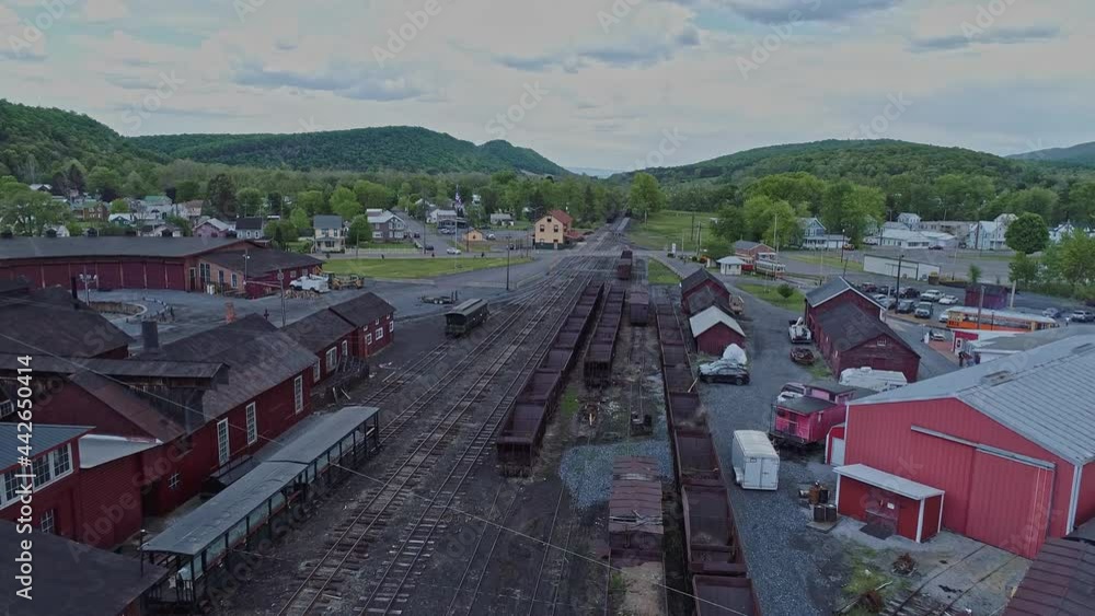 An Aerial View of an Abandoned Narrow Gauge Coal Rail Road with Rusting Hoppers and Freight Cars and Support Building Starting to be Restored An Aerial View of an Abandoned Narrow Gauge Coal Rail Road with Rusting Hoppers and Freight Cars and Support Building Starting to be Restored