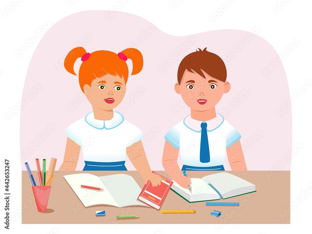 Schoolchildren are sitting at a desk. The concept of raising children of primary school age.