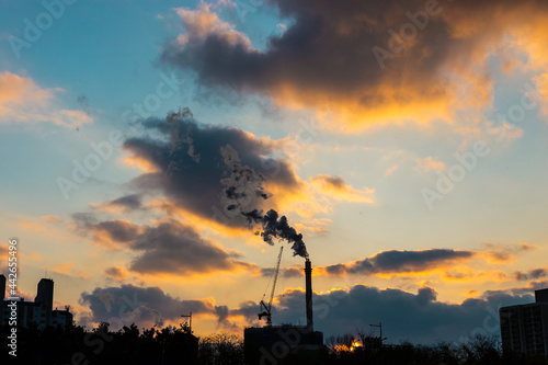 Orange sunset with smoke factory