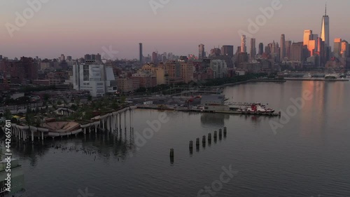 Wallpaper Mural An aerial view of Manhattan's Little Island in the morning. The camera dolly in and tilt down over the calm Hudson River showing the colorful sky and the Freedom Tower in the distance. Torontodigital.ca