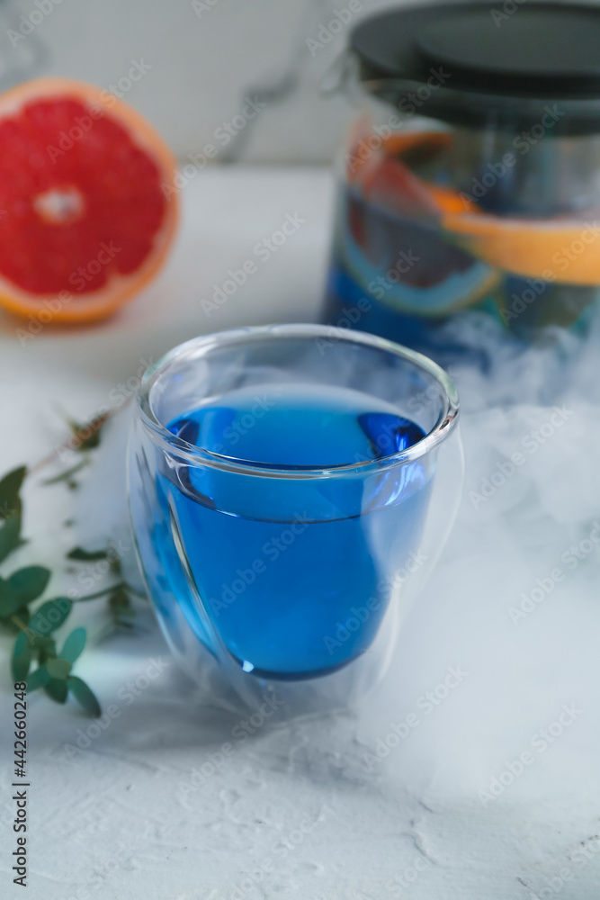 Glass of hot blue tea on table Glass of hot blue tea on table