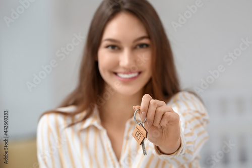 Happy young woman with key ...