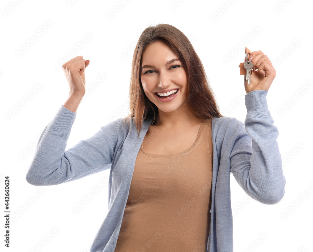 Obraz premium Happy young woman with key from house on white background