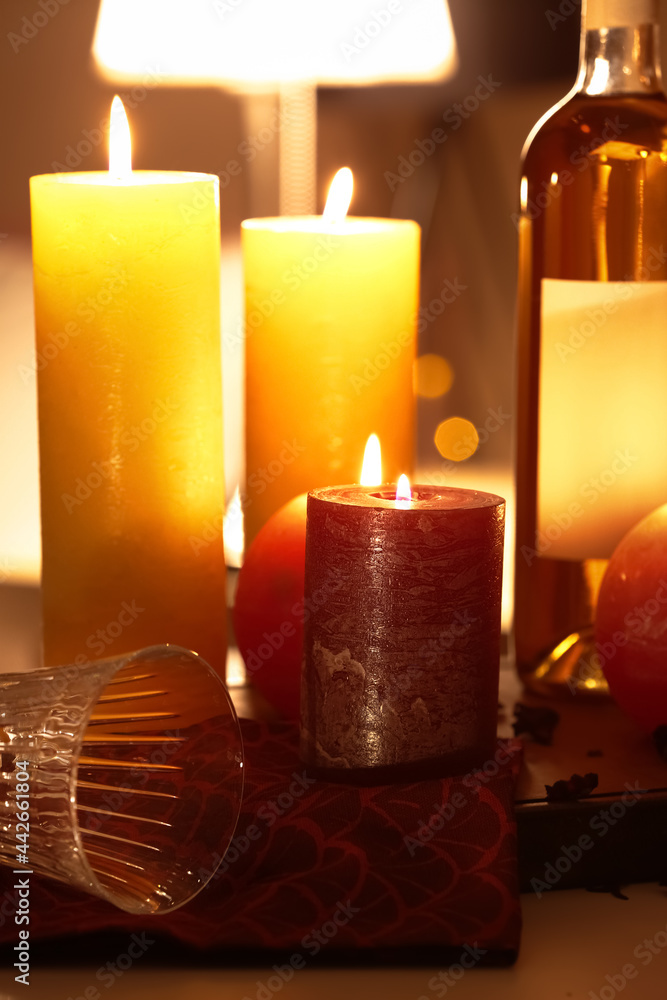 Burning candles on table in room Burning candles on table in room