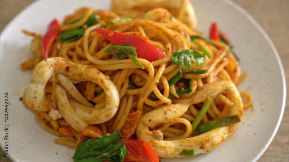 stir-fried spaghetti with salted egg and squid - fusion food style stir-fried spaghetti with salted egg and squid - fusion food style