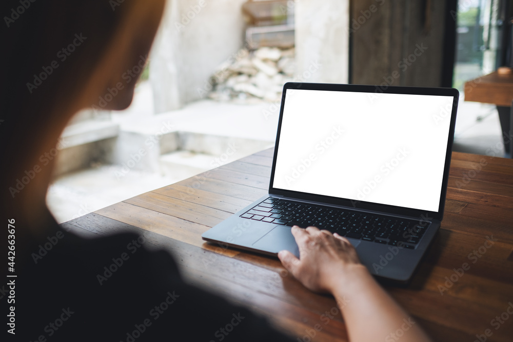 Mockup image of a woman using and touching on laptop touchpad with blank white desktop screen - obrazy, fototapety, plakaty 