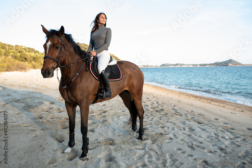 Wallpaper Mural Woman riding stallion on ocean coast against mountain Torontodigital.ca
