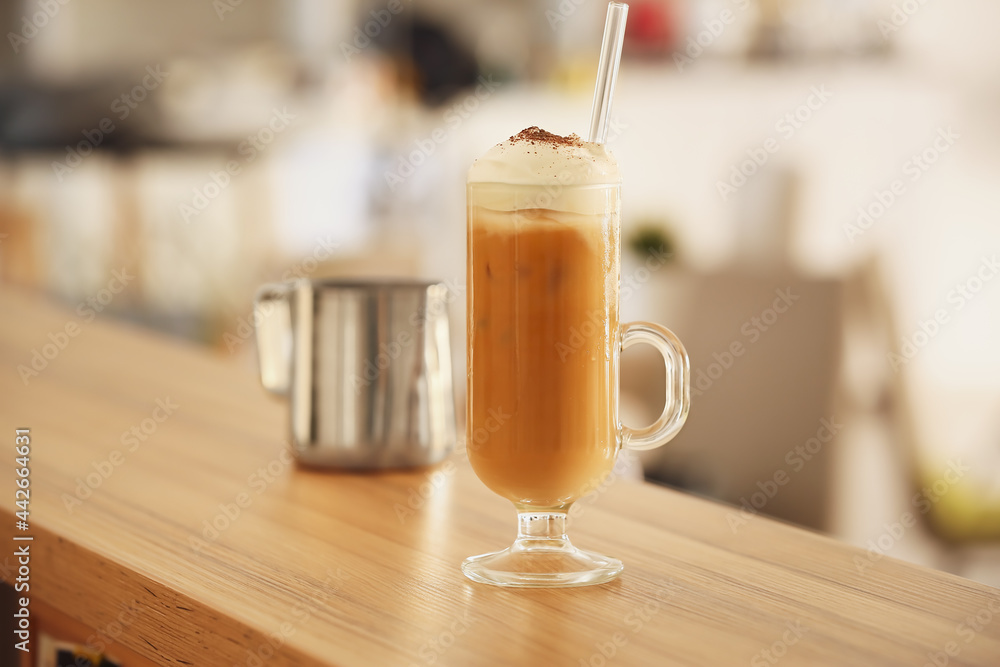 Glass of tasty iced coffee on wooden table Glass of tasty iced coffee on wooden table