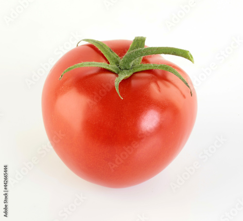 One Ripe red tomatoe on white