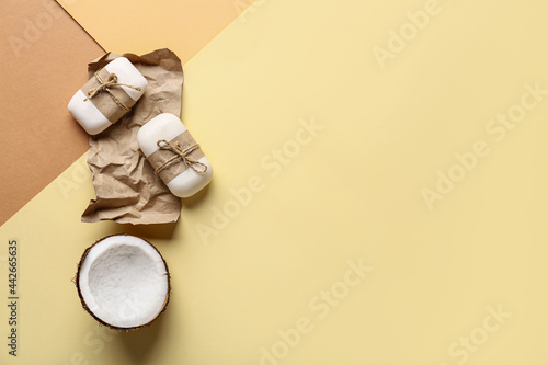 Composition with soap bars and coconut on color background
