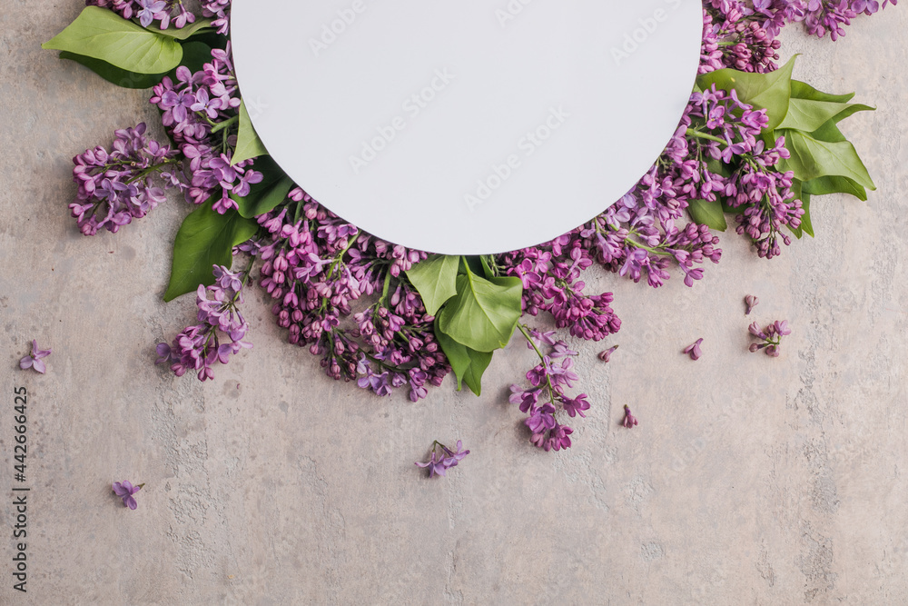 blossom Syringa vulgaris in Lilac flower and blank paper card for text message.Top view. Romantic flowers composition. Mock up frame with lilac flowers on purple background blossom Syringa vulgaris in Lilac flower and blank paper card for text message.Top view. Romantic flowers composition. Mock up frame with lilac flowers on purple background