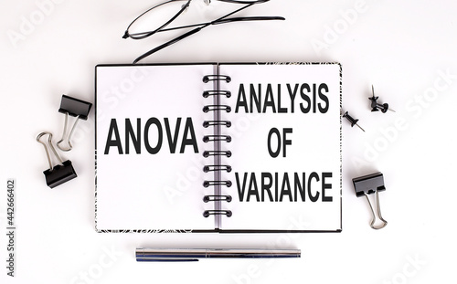 Notebook with ANOVA ANALYSIS OF VARIANCE on a table photo
