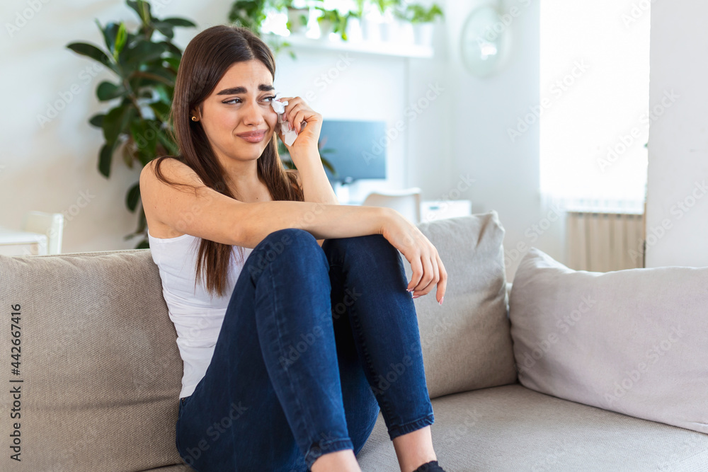 Unhappy young woman covering face with hands, crying alone close up, depressed girl sitting on couch at home, health problem or thinking about bad relationships, break up with boyfriend, divorce Unhappy young woman covering face with hands, crying alone close up, depressed girl sitting on couch at home, health problem or thinking about bad relationships, break up with boyfriend, divorce