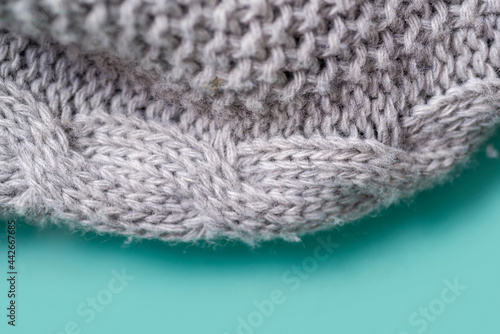 Fragment of a gray knitted plaid close-up. 