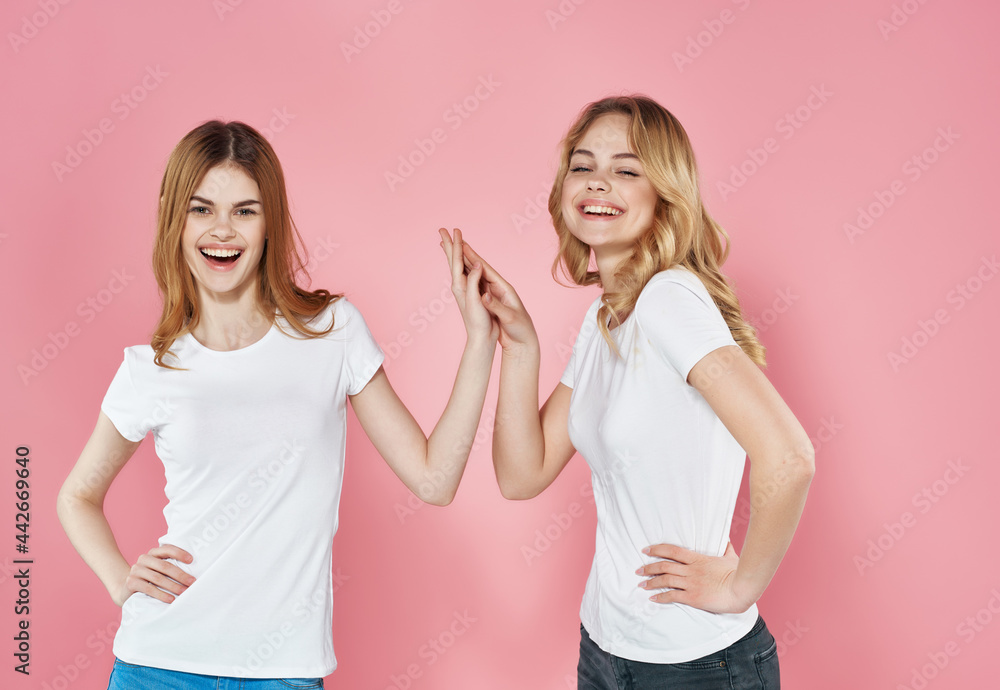 two cute girlfriends in white t-shirts emotions friendship fashion two cute girlfriends in white t-shirts emotions friendship fashion