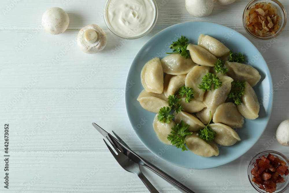 Concept of tasty food with vareniki or pierogi on wooden table Concept of tasty food with vareniki or pierogi on wooden table