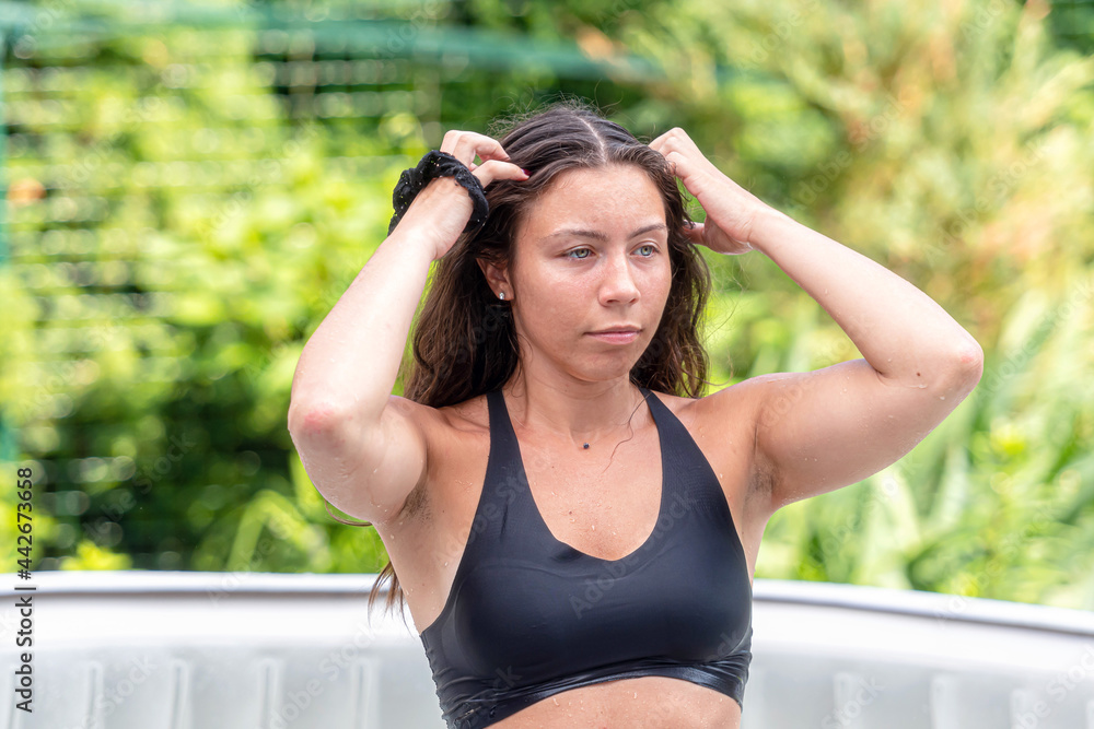gorgeous teenage girl with long, dark hair relaxes in the garden inflatable pool with jacuzzi gorgeous teenage girl with long, dark hair relaxes in the garden inflatable pool with jacuzzi