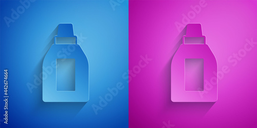 Paper cut Plastic bottle for laundry detergent, bleach, dishwashing liquid or another cleaning agent icon isolated on blue and purple background. Paper art style. Vector