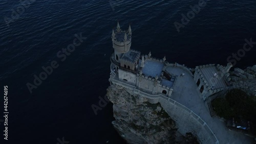 Flight over the Swallow's Nest castle and the Black Sea at sunset in Crimea.