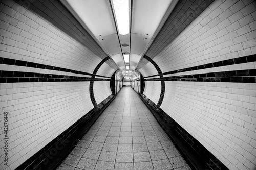 Tunnel Super Wide Angle of Tunnel Symmetrical Walkway with tiles on the ceiling and floor and walls photo