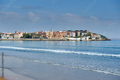 surfer on the beach of san lorenzo in Gijon