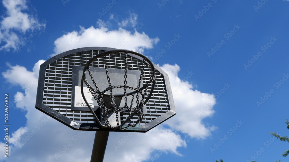 Metal basketball hoop under clear blue sky Metal basketball hoop under clear blue sky