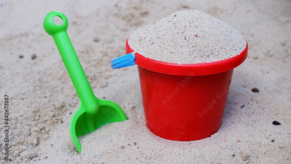 Sand toys with shovel and bucket in a sandpit Sand toys with shovel and bucket in a sandpit