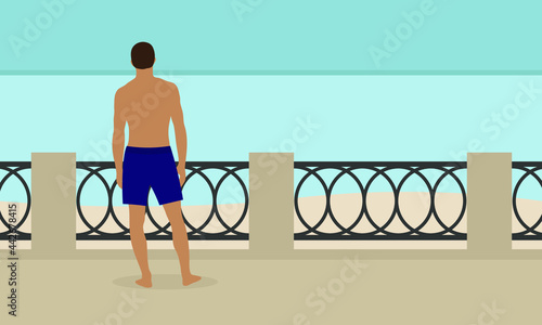Male character in shorts stands on the embankment and looks at the sea