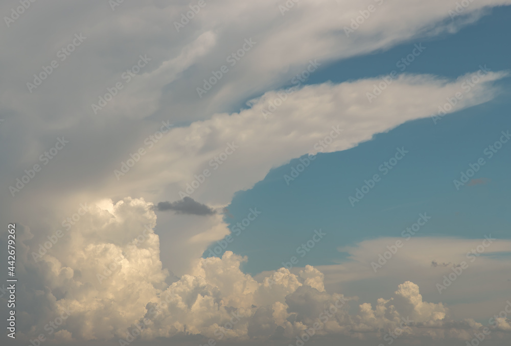 The sun shines through the clouds in the sky. The shape of the clouds evokes imagination and creativity. Copy space, Selective focus. The sun shines through the clouds in the sky. The shape of the clouds evokes imagination and creativity. Copy space, Selective focus.