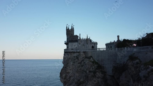 Flight over the Swallow's Nest castle and the Black Sea at sunset in Crimea.