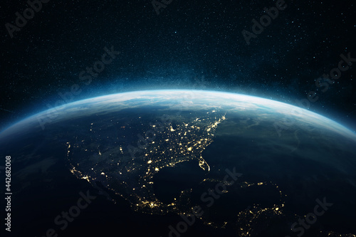Fototapeta Naklejka Na Ścianę i Meble -  Beautiful blue planet earth with lights of night cities USA, South and North America. View of the night planet from space