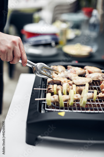 Preparing barbeque on a electrical modern grill outdoors.