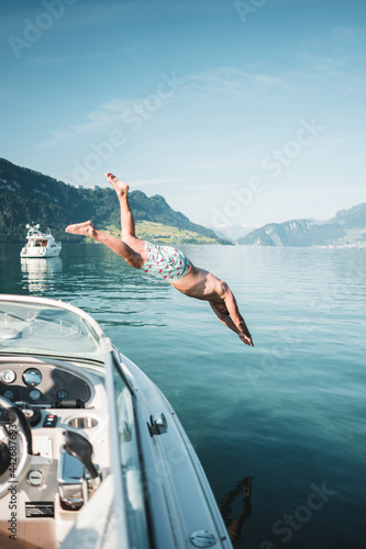 Man jumping from a boat into a lake, Switzerland