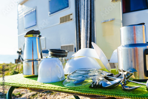 Clean dishes drying on fresh air, capming outdoor photo