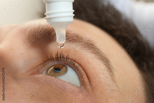 Bild auf Leinwand Closeup view of man using eye drops